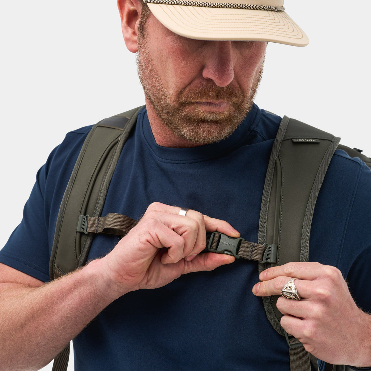 Traveler wearing NOMATIC Travel Bag 30L in olive