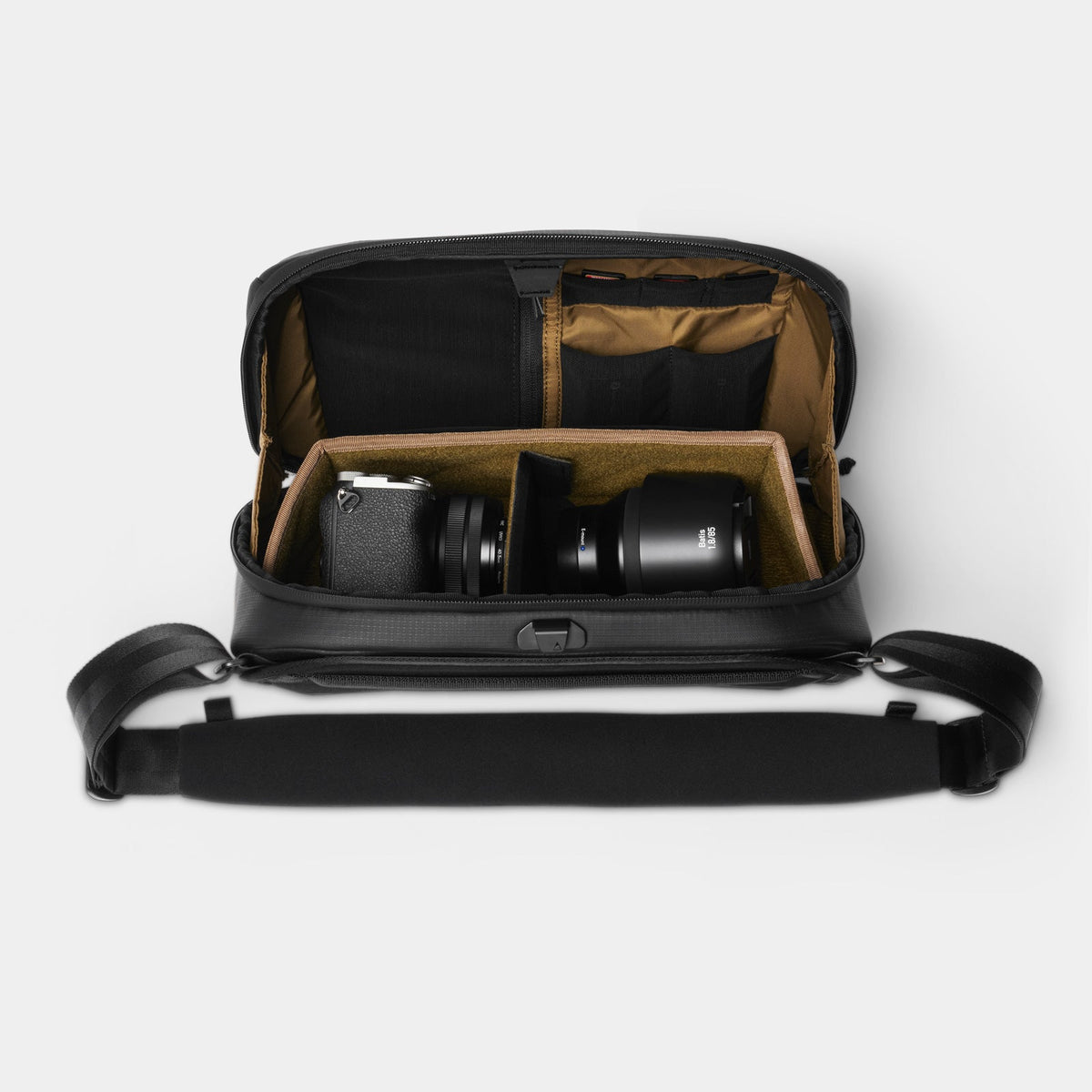 Black camera bag with compartments on a white background