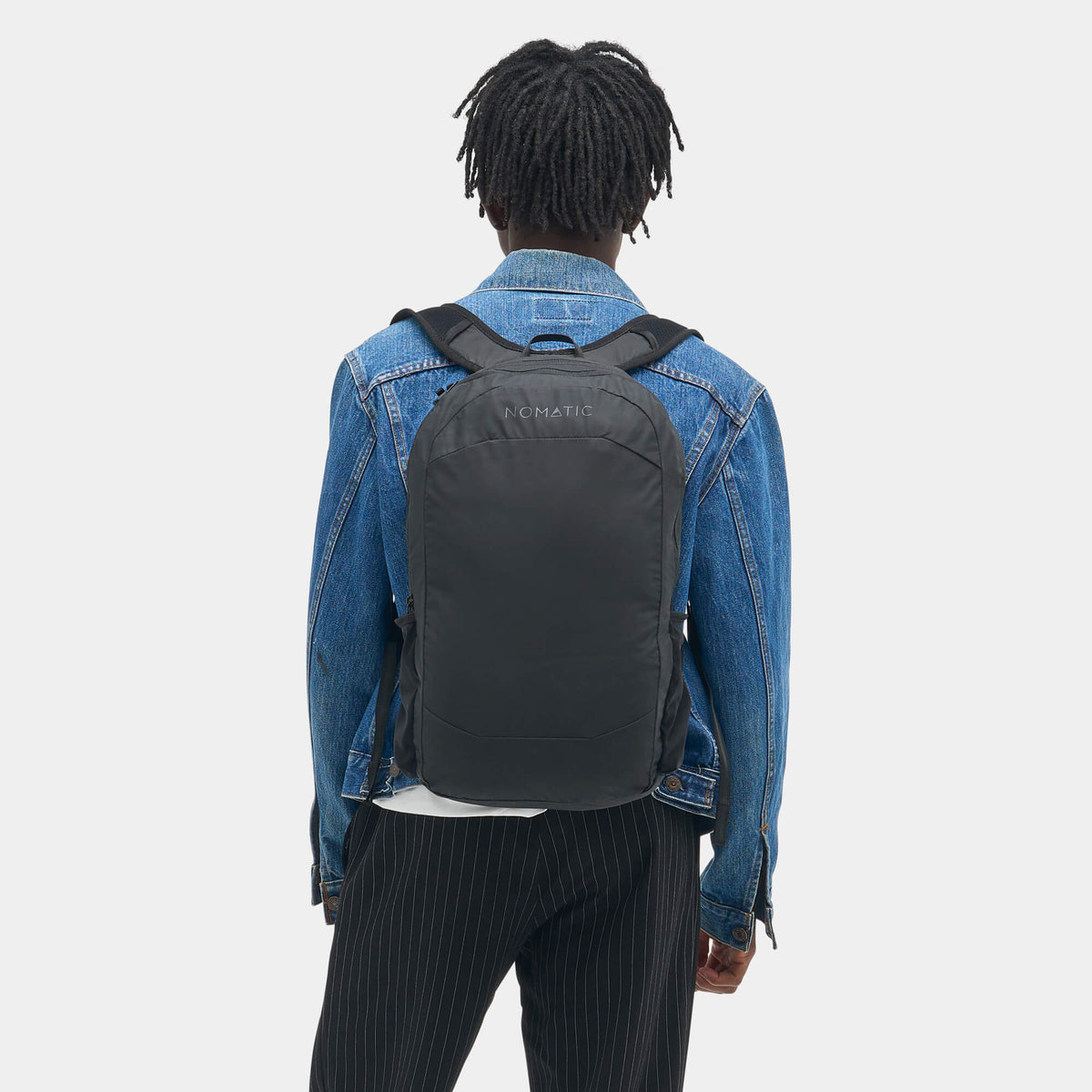 Collapsed Navigator Collapsible Pack 16L shown on person back view