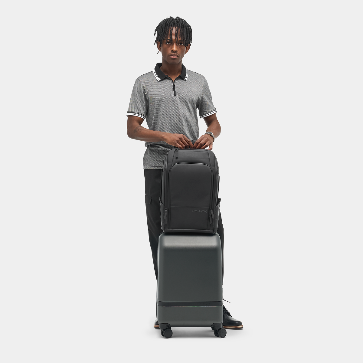 Nomatic Travel Pack 14L on model in airport showing personal item carry
