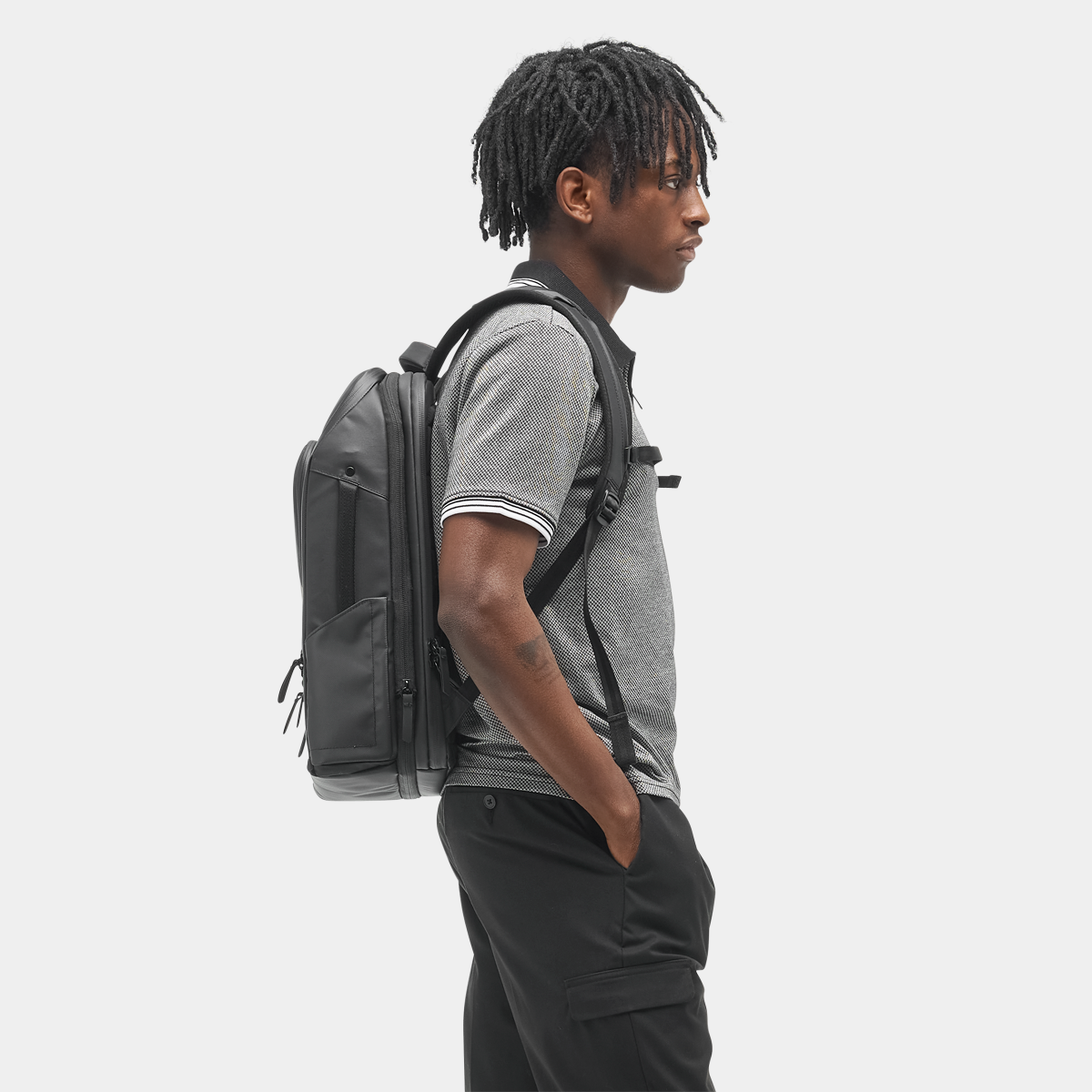Nomatic Travel Pack 14L side view showing magnetic water bottle pocket - black