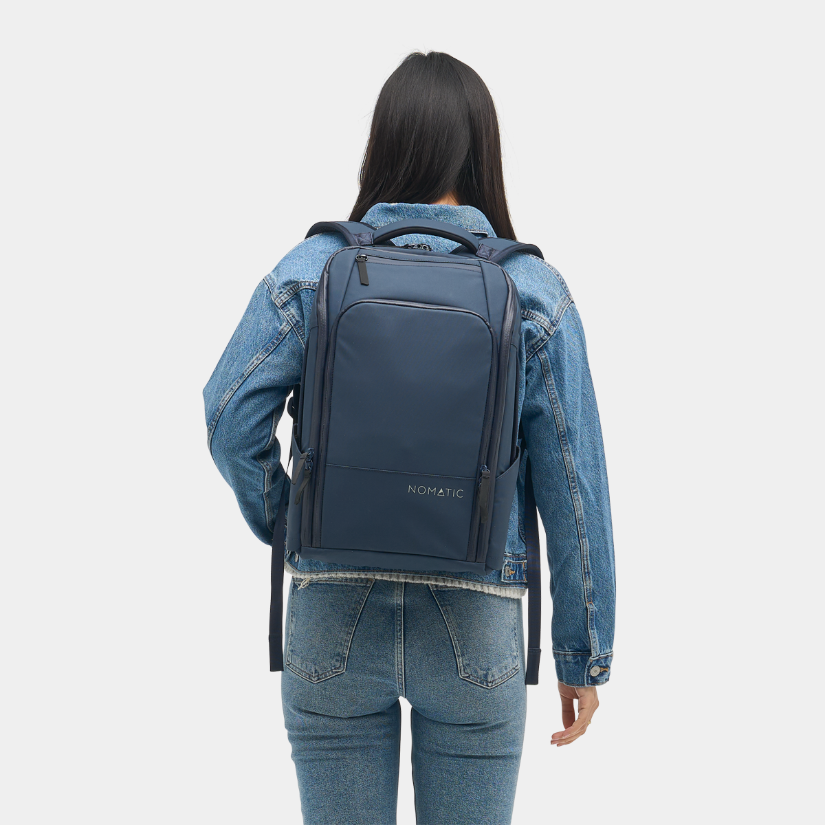 Nomatic Travel Pack 14L navy on model - lifestyle commute shot