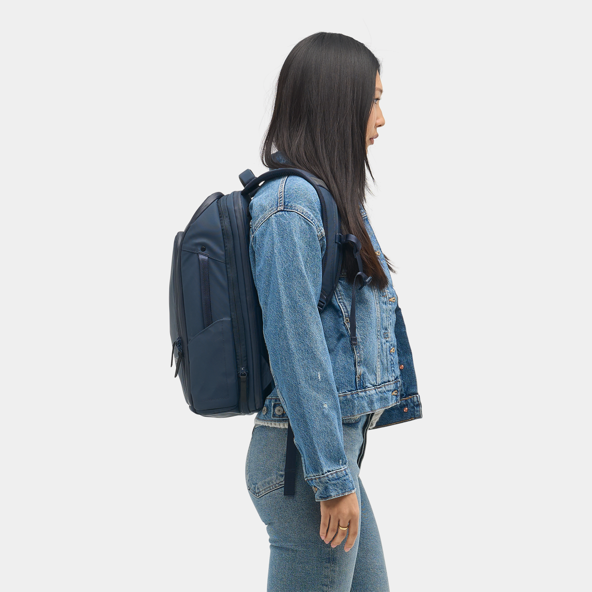Nomatic Travel Pack 14L navy side view showing water bottle pocket