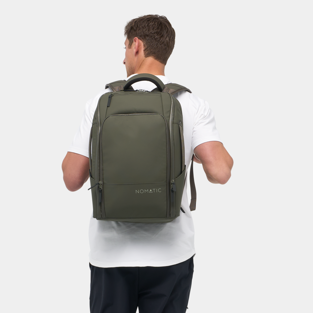 Nomatic Travel Pack 20L olive on model showing comfortable backpack carry