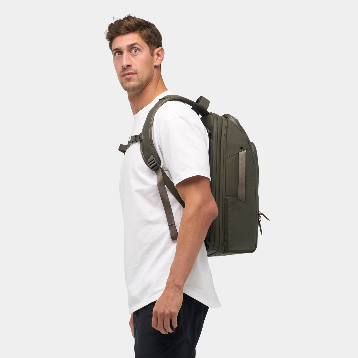 Nomatic Travel Pack 20L olive on model - outdoor travel lifestyle shot